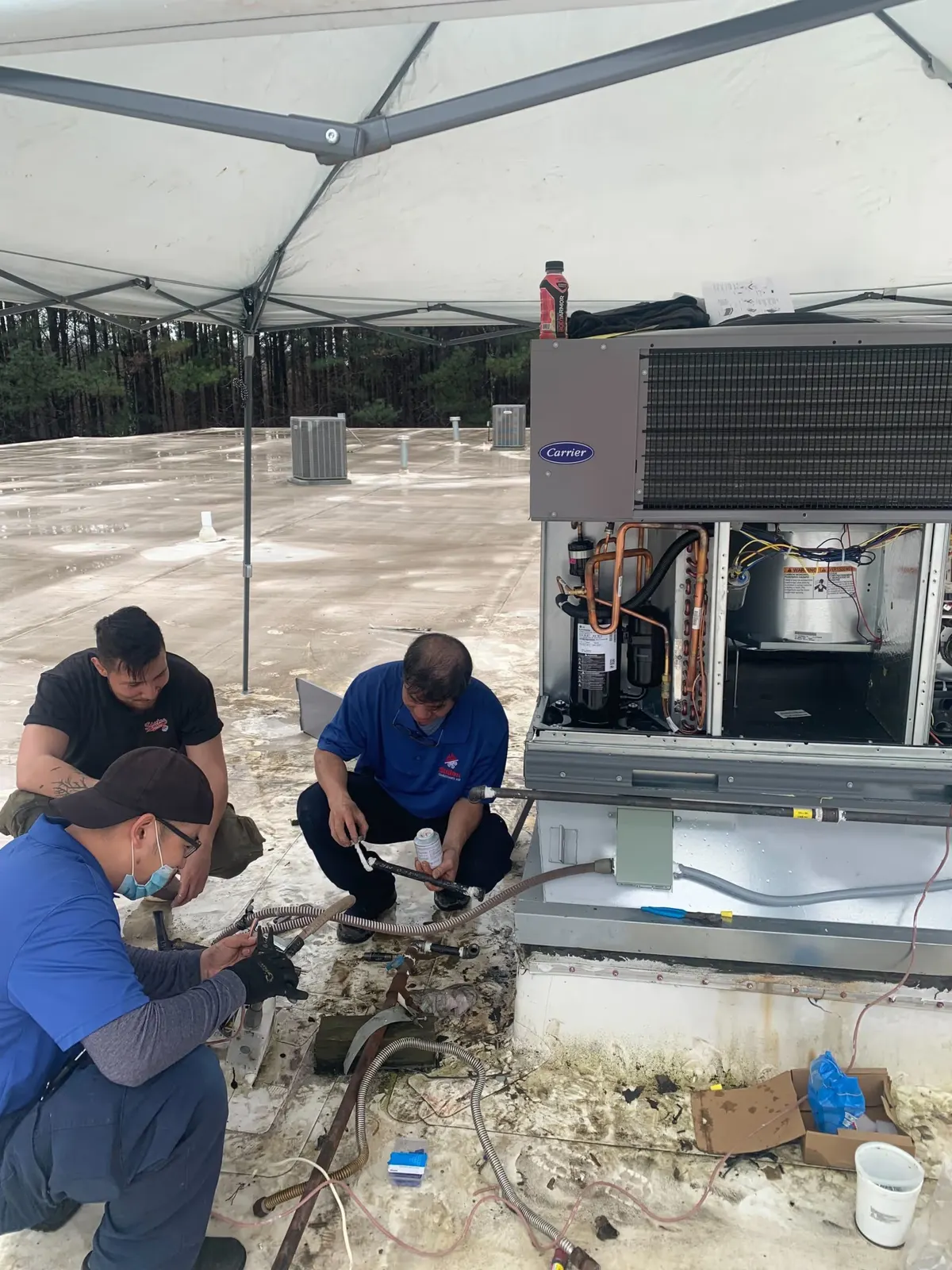 Staton technicians servicing a commercial rooftop HVAC unit