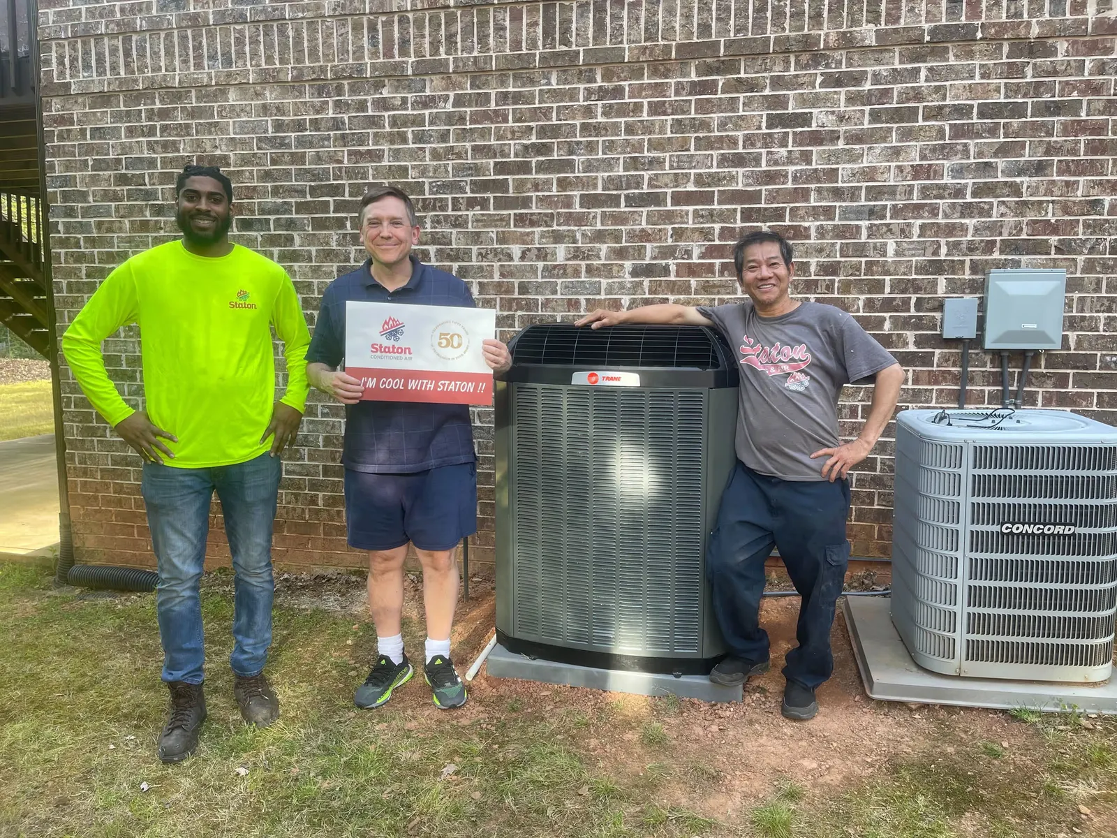 Staton crew and homeowner with a new condenser installation