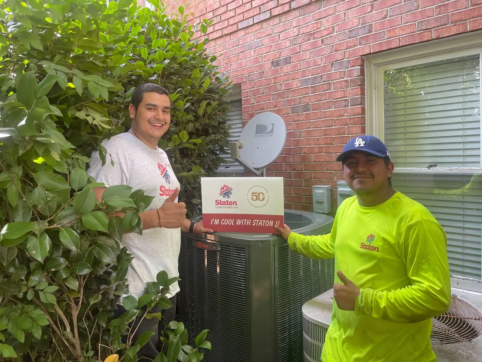 Install crew with a freshly set outdoor condenser
