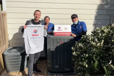 Install crew presenting a Staton Heating & Air shirt on install day