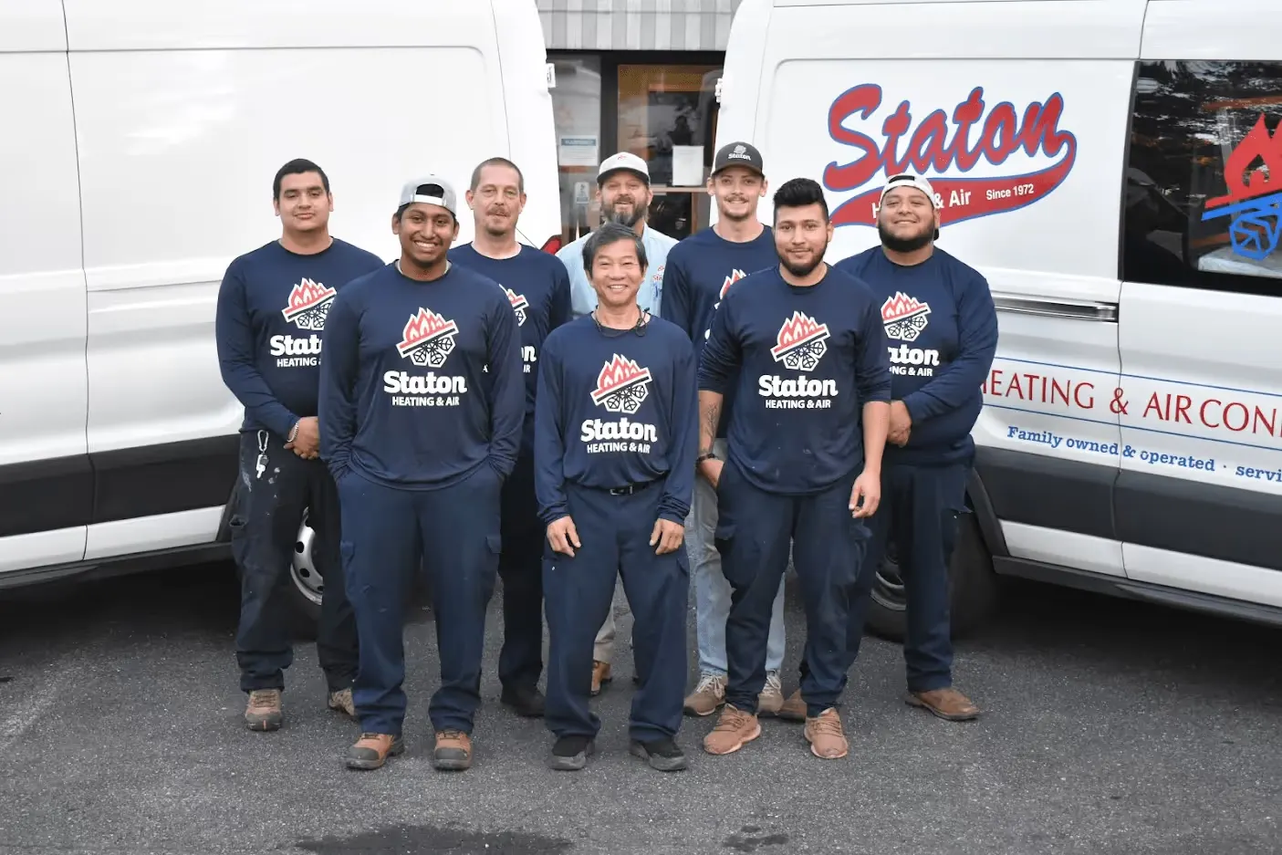 The Staton Heating & Air team in front of the company vans
