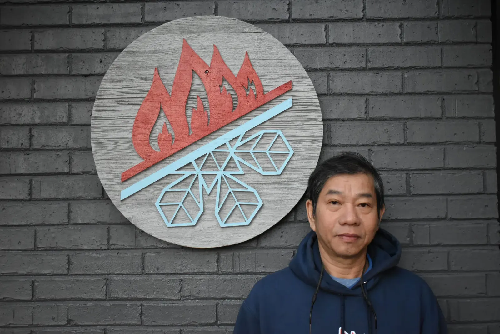 Staton team member at the office logo wall