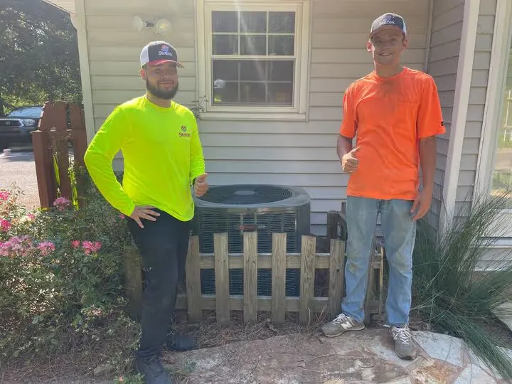 Staton technician after servicing an outdoor AC unit