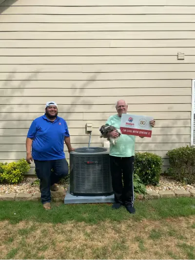 Technicians with a completed condenser installation