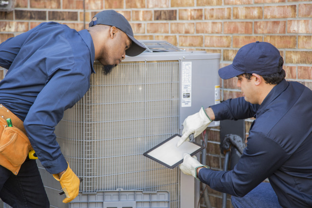 Ac technicians fixing an AC system | Staton Heating & Air